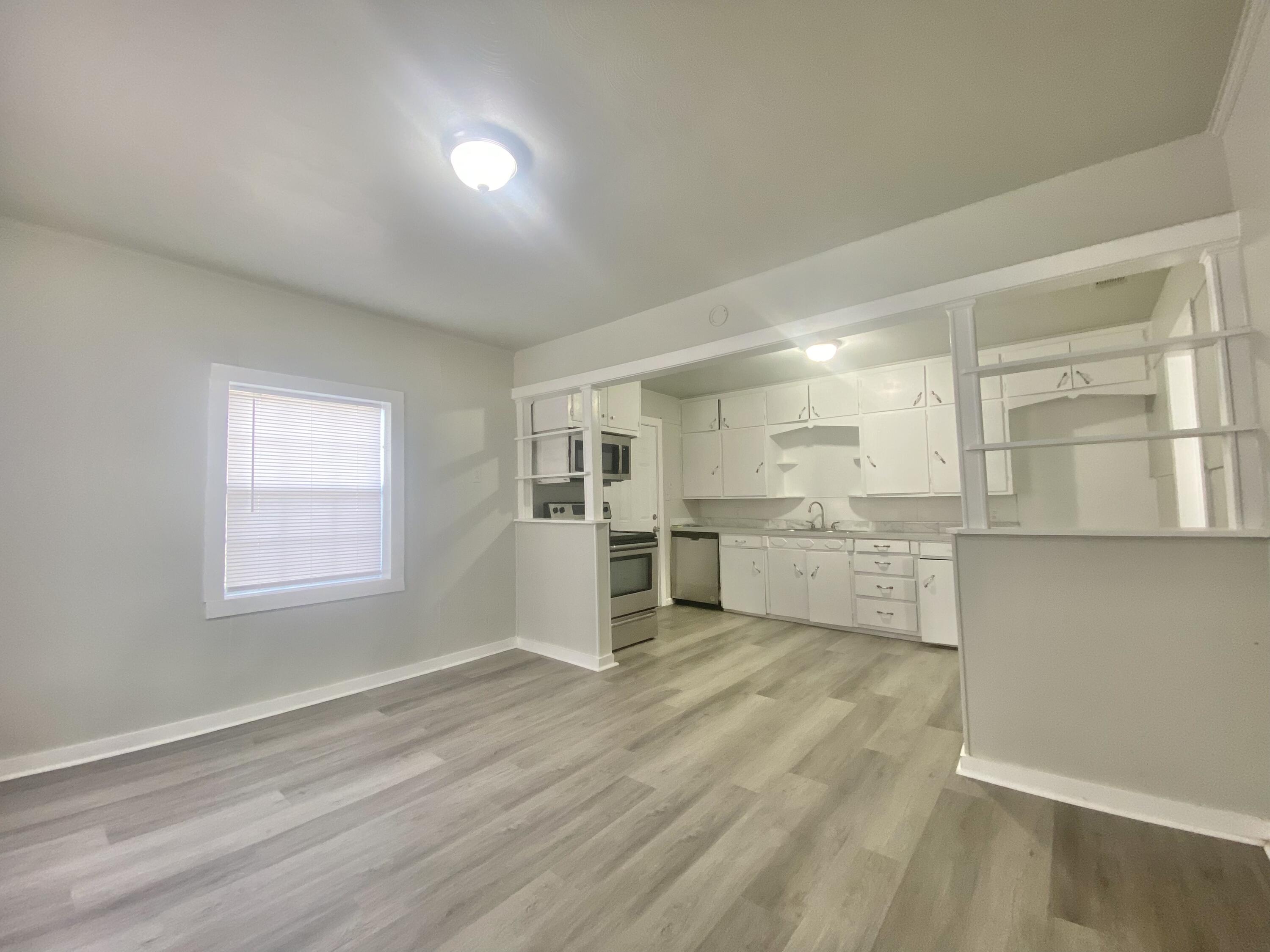 5701 45th Street Lubbock, TX 79414 - Photo 6 of 12 a view of a kitchen with wooden floor
