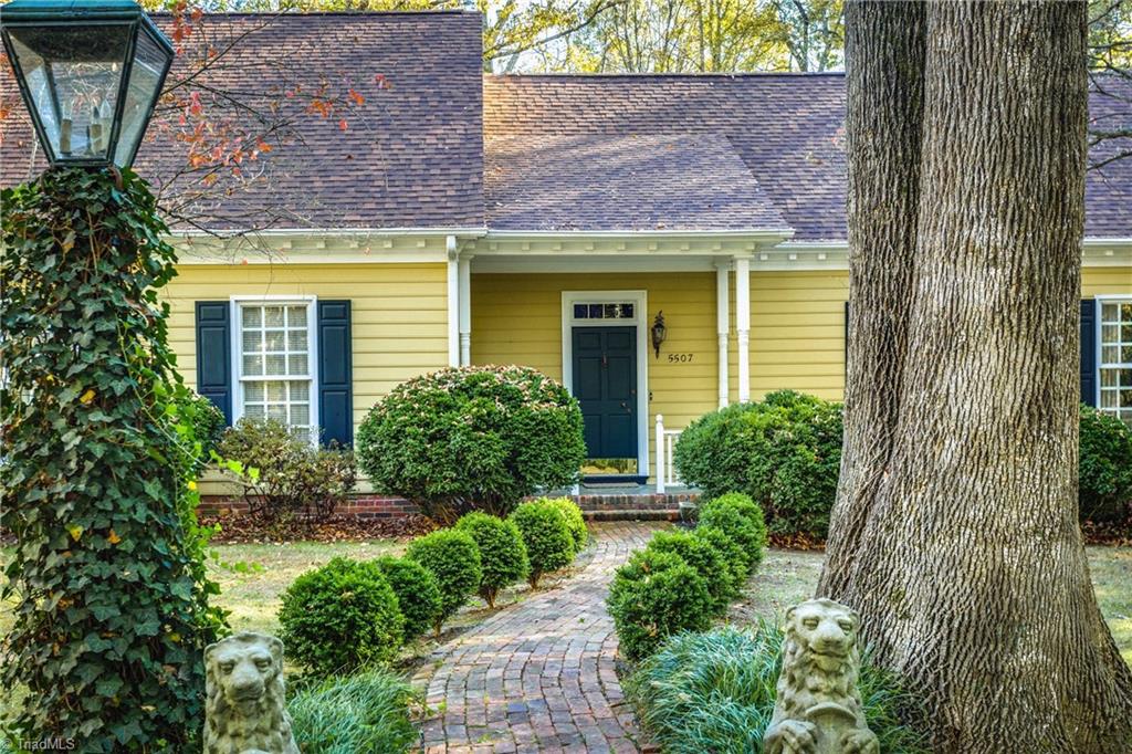5507 East Rockingham Road Greensboro, NC 27407 - Photo 3 of 29 Beautiful Boxwoods greet you as you meander along this brick walkway up to the front door.