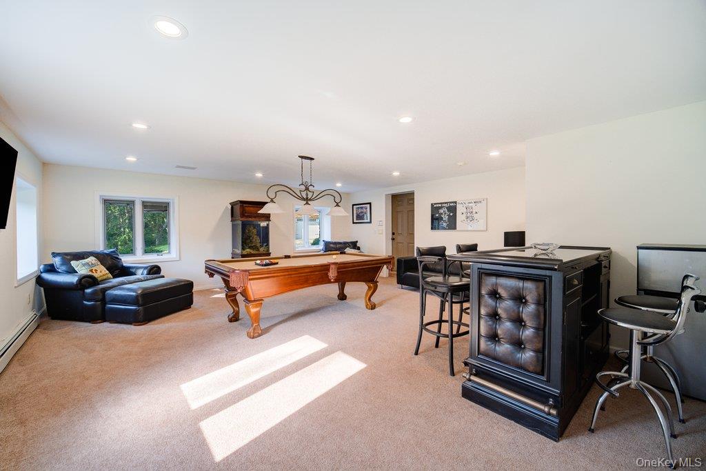 237 Mineral Springs Road Highland Mills, NY 10930 - Photo 28 of 32 a living room with furniture a flat screen tv and a table