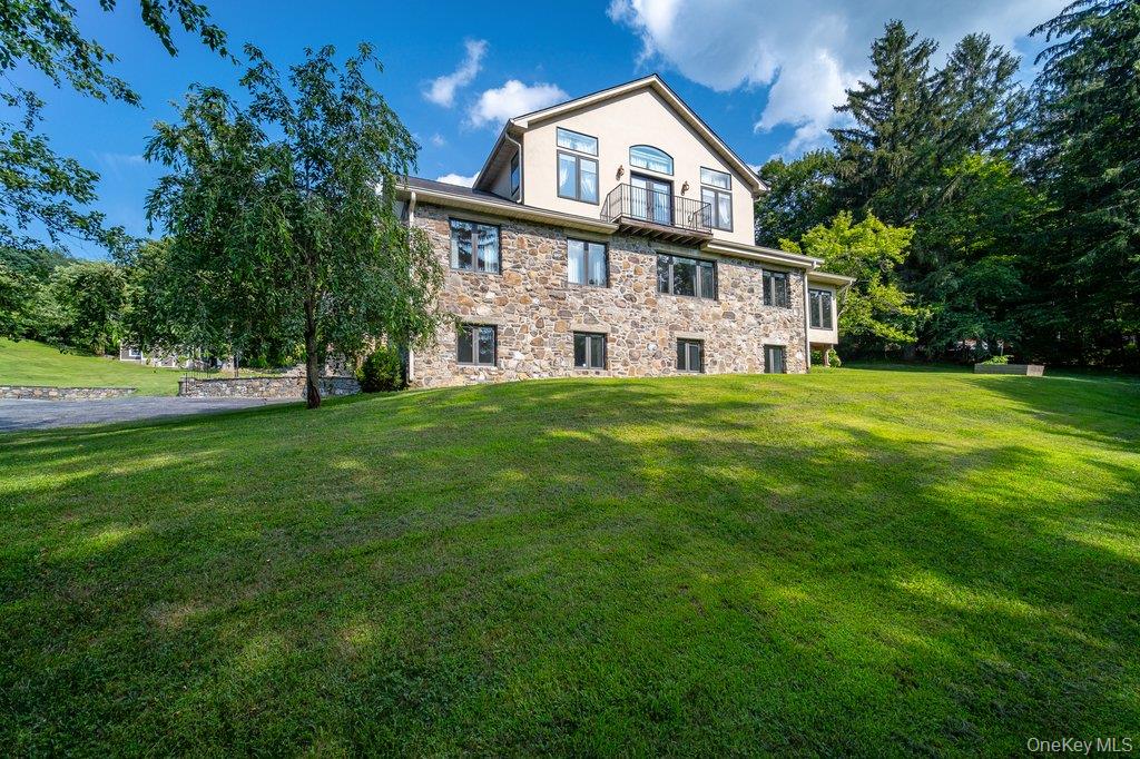 237 Mineral Springs Road Highland Mills, NY 10930 - Photo 5 of 32 a view of a white house with a big yard and large trees