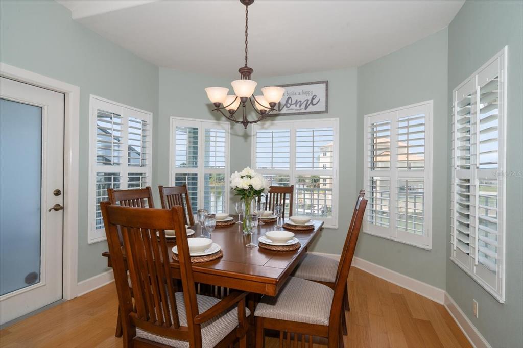 3397 Bluefish Drive Hernando Beach, FL 34607 - Photo 24 of 65 a view of a dining room with furniture wooden floor and chandelier