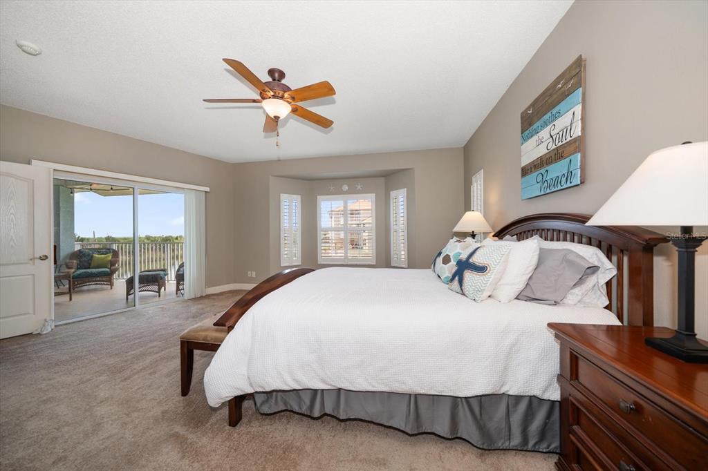 3397 Bluefish Drive Hernando Beach, FL 34607 - Photo 30 of 65 a spacious bedroom with a bed a table and large window