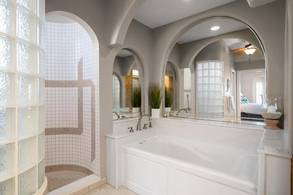 3397 Bluefish Drive Hernando Beach, FL 34607 - Photo 31 of 65 a bathroom with a bathtub a double vanity sink and mirror