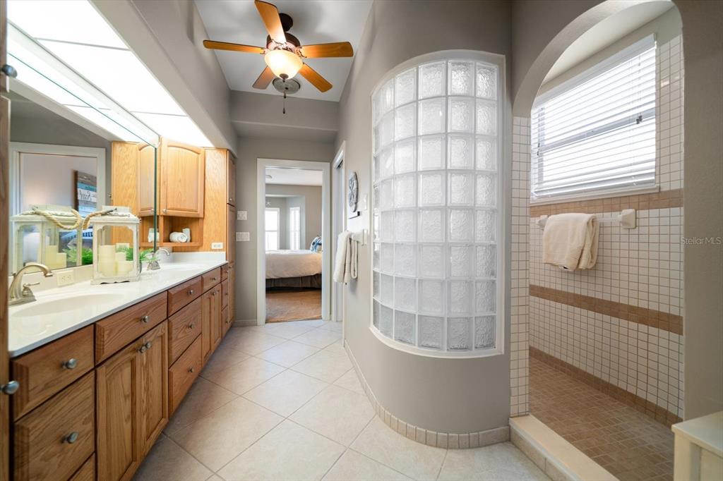 3397 Bluefish Drive Hernando Beach, FL 34607 - Photo 33 of 65 a bathroom with a double vanity sink a toilet and shower