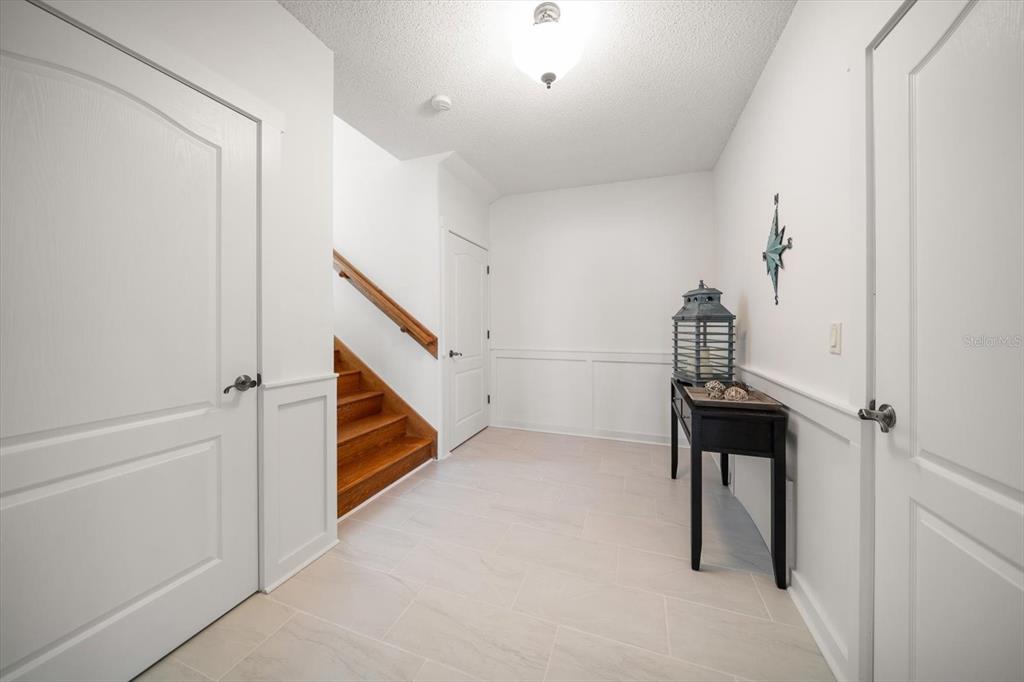 3397 Bluefish Drive Hernando Beach, FL 34607 - Photo 35 of 65 a view of entryway with stairs and wooden floor