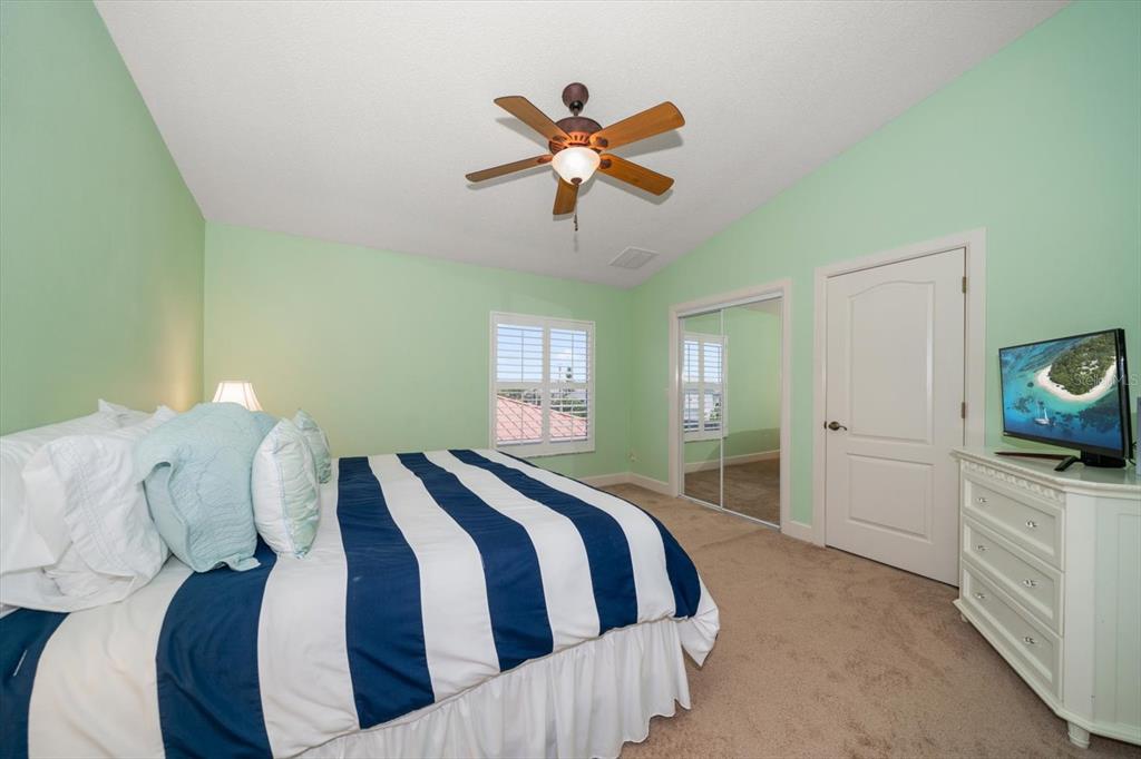 3397 Bluefish Drive Hernando Beach, FL 34607 - Photo 43 of 65 a bedroom with a bed and a chandelier