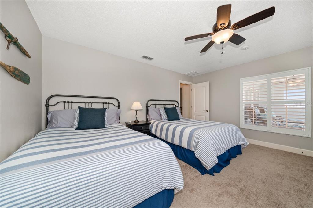 3397 Bluefish Drive Hernando Beach, FL 34607 - Photo 44 of 65 a bedroom with two beds and a chandelier