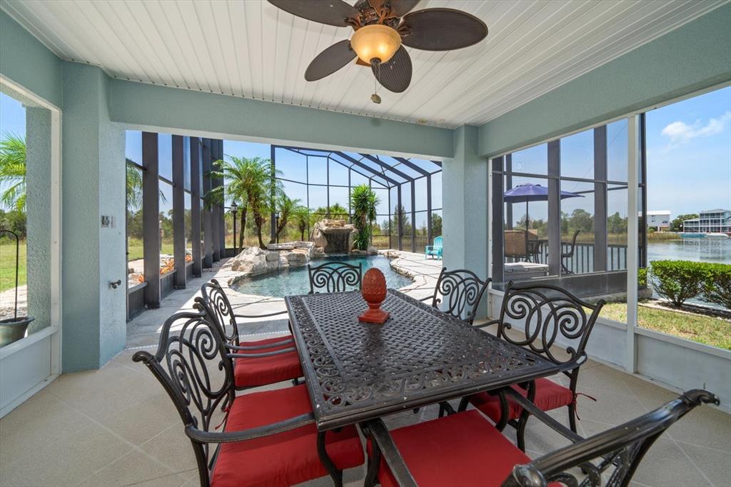 3397 Bluefish Drive Hernando Beach, FL 34607 - Photo 47 of 65 a dining room with furniture a chandelier and a large window