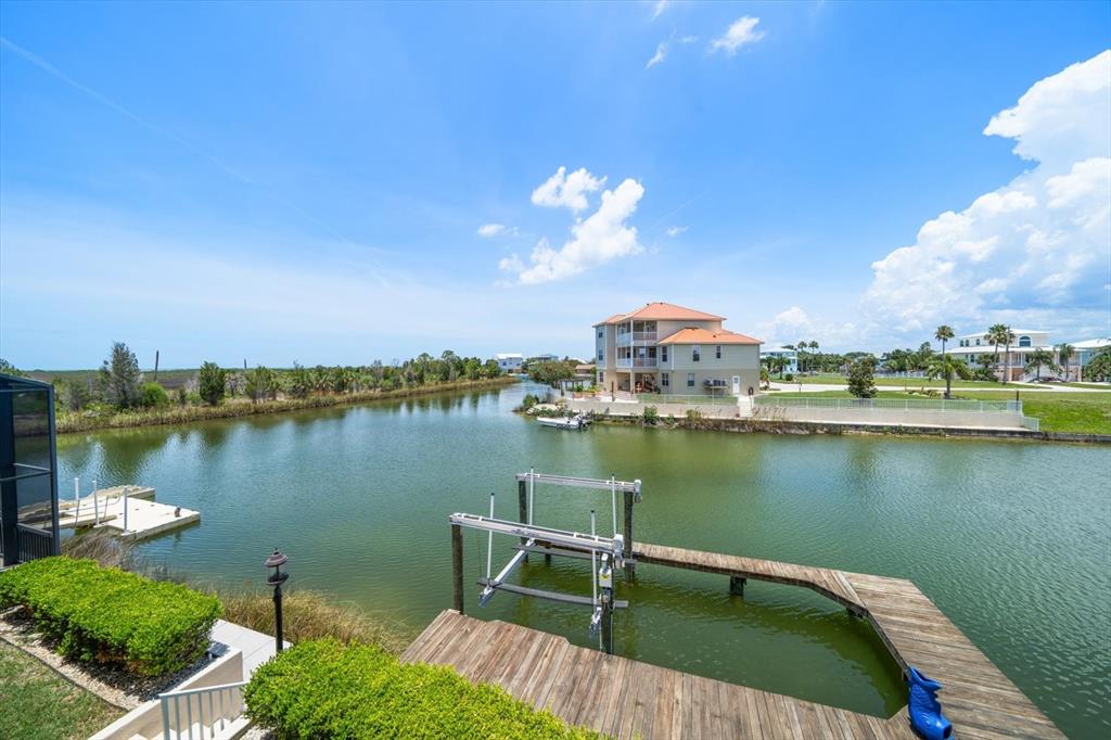 3397 Bluefish Drive Hernando Beach, FL 34607 - Photo 52 of 65 a view of a lake with a table and chairs