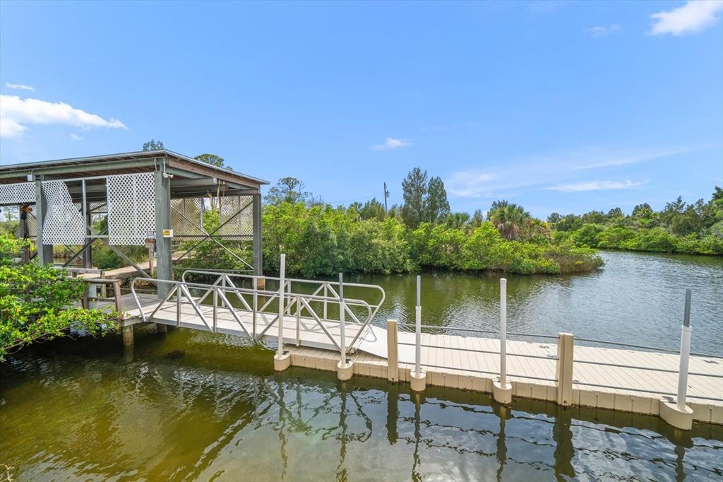 3397 Bluefish Drive Hernando Beach, FL 34607 - Photo 55 of 65 a view of a lake with a house in the background