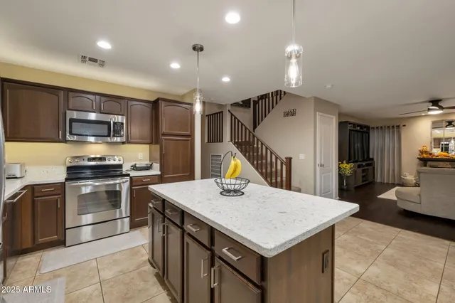 a kitchen with a stove a refrigerator and a microwave