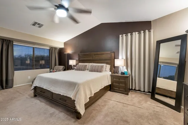 a bed room with a bed and a mirror