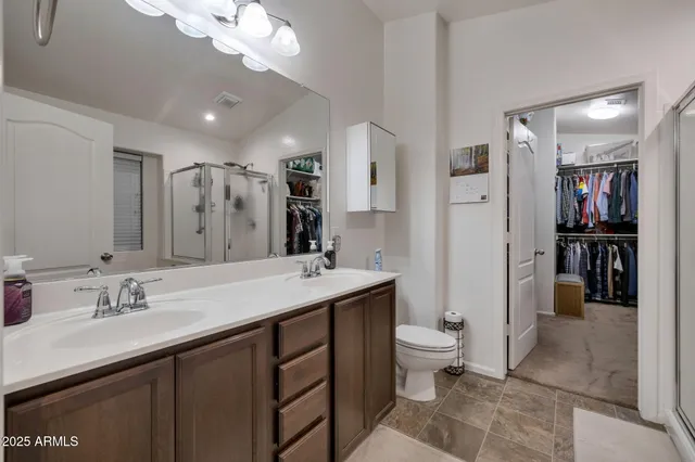 a spacious bathroom with a shower sink and toilet