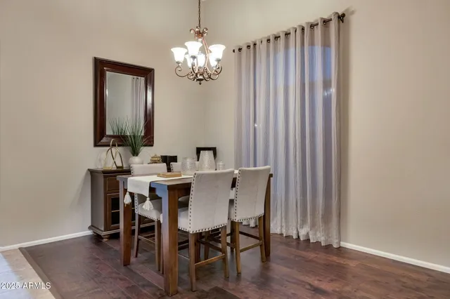 a view of a dining room with furniture and chandelier