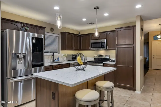a kitchen with a refrigerator a sink and cabinets