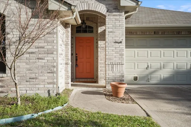 a front view of a house with a yard and seating space