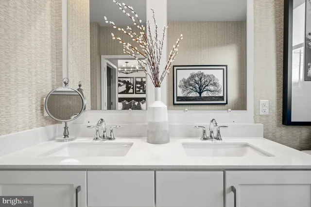 a bathroom with a double vanity sink toilet and a mirror