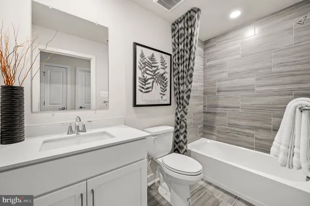 a bedroom with a bed and a potted plant