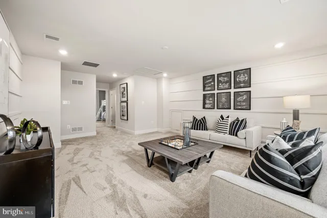 a bedroom with furniture and a large window