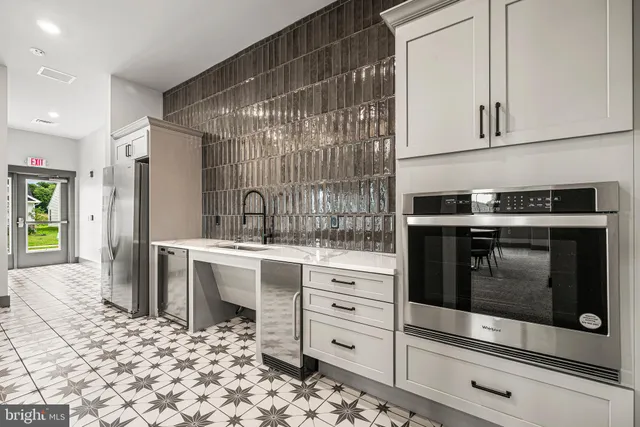 a large white kitchen with a large window