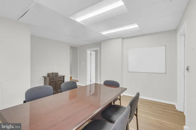 a view of a workspace with furniture and wooden floor