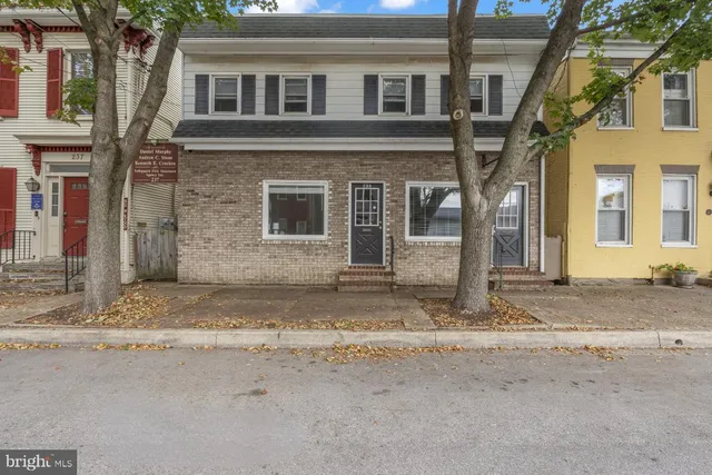 a view of a brick house with many windows