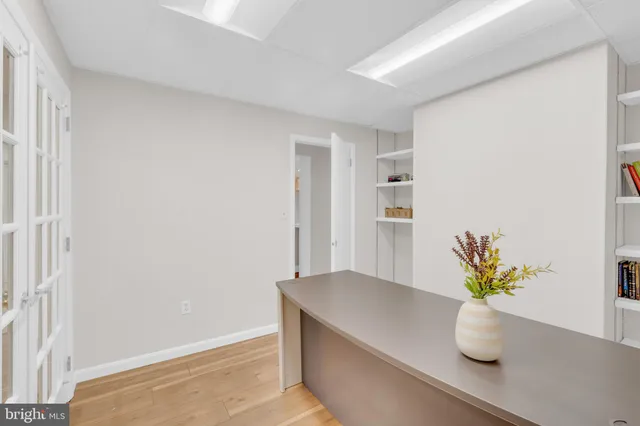 a white vase with white and yellow flowers