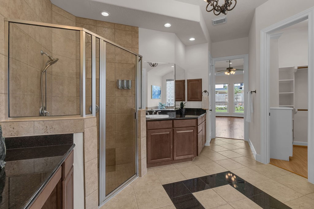 7306 Starflower Katy, TX 77494 - Photo 30 of 50 a large bathroom with a glass door shower and sink