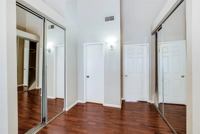 a bathroom with a granite countertop sink toilet mirror and shower