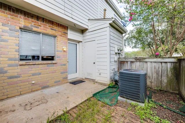 a view of backyard with wooden fence and large trees