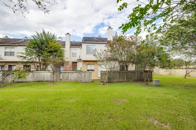 a view of a tree in front of a house