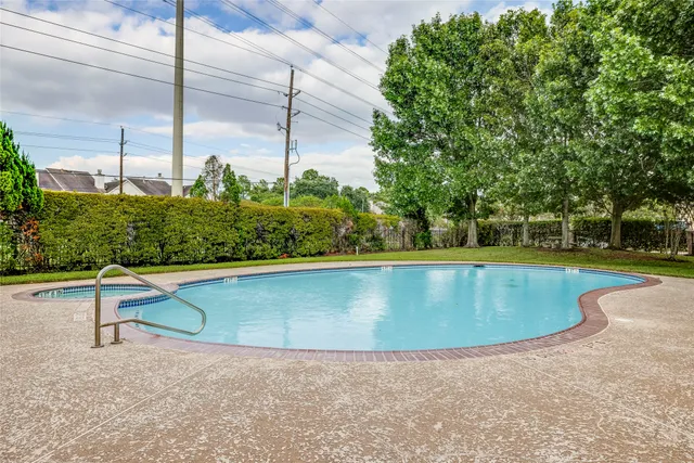 a view of a swimming pool with a yard