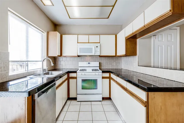 a kitchen that has a sink and a stove