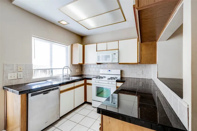 a kitchen with stainless steel appliances a stove sink and cabinets