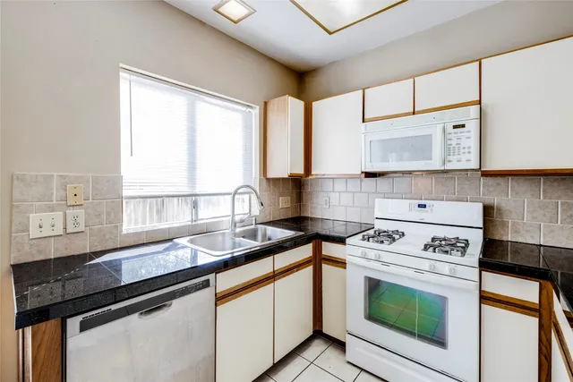 a white refrigerator freezer and a wooden floor