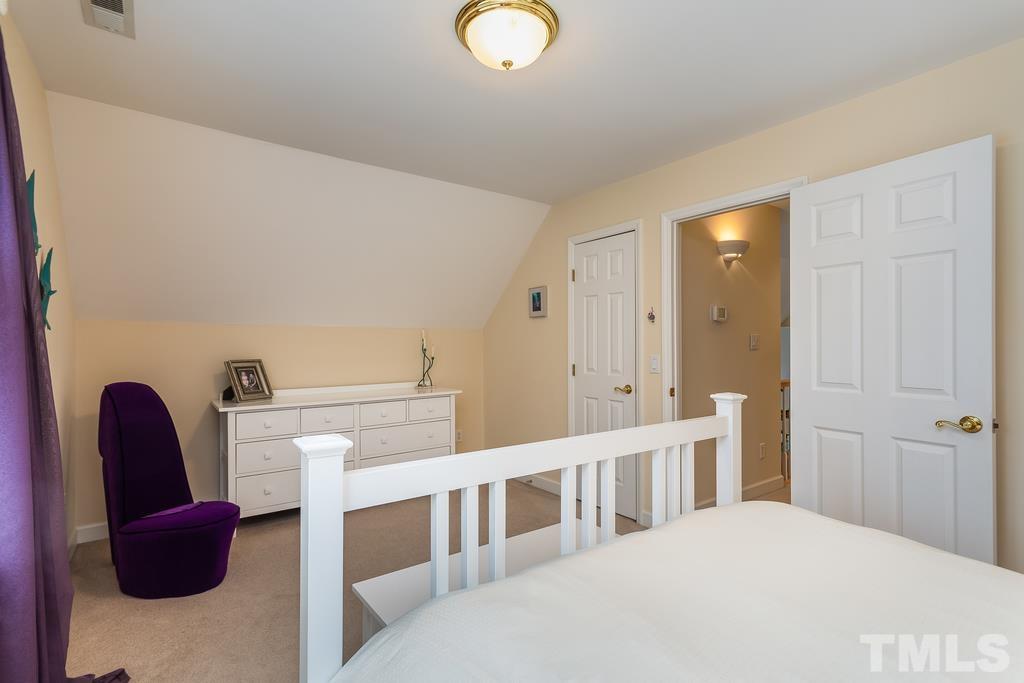 2405 Andor Place Raleigh, NC 27604 - Photo 19 of 30 a bedroom with a bed and a chair
