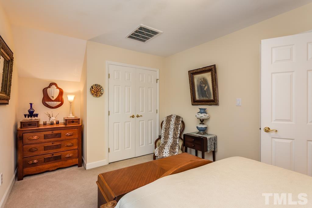 2405 Andor Place Raleigh, NC 27604 - Photo 22 of 30 a bedroom with a bed and a dresser