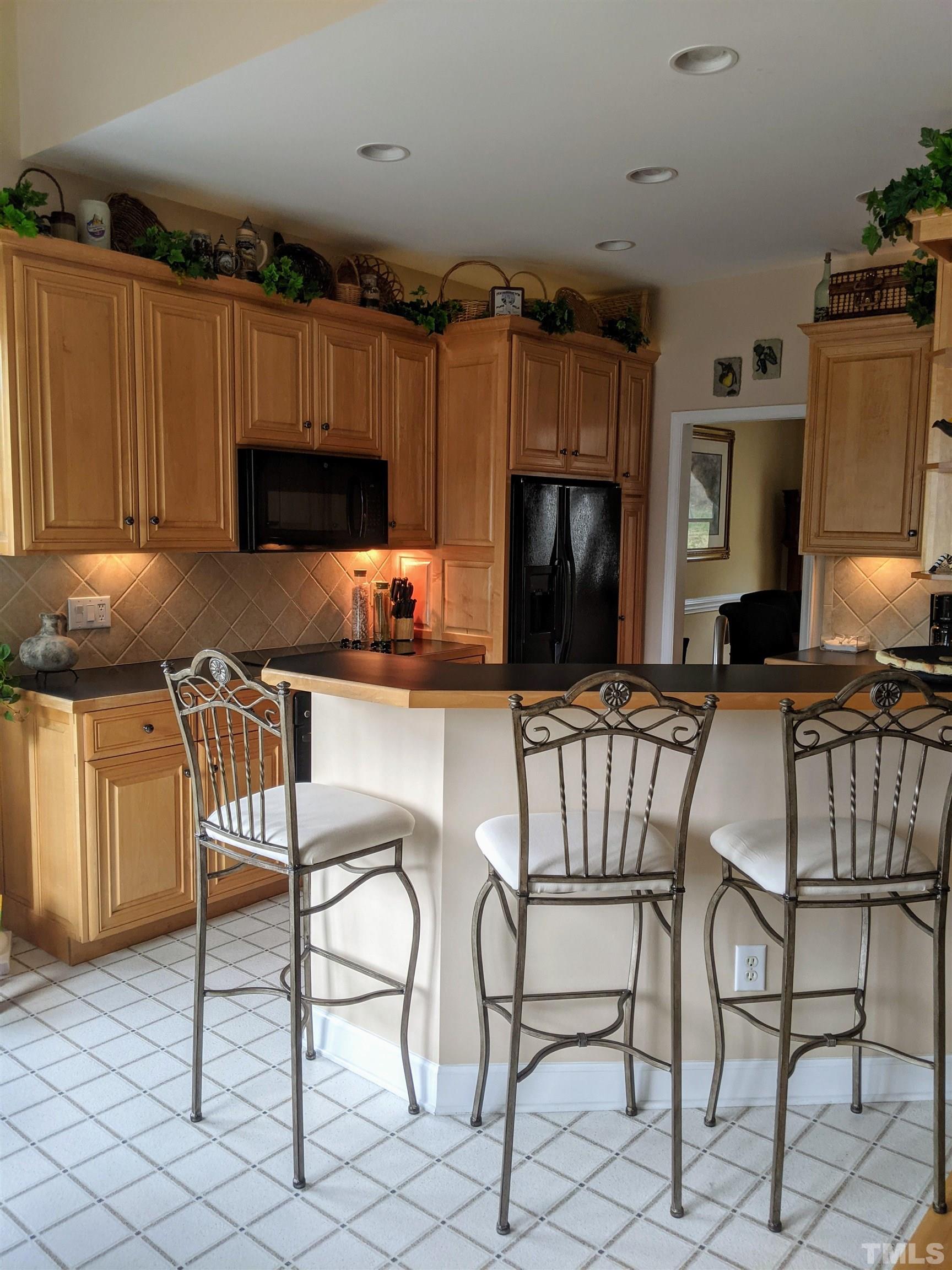 2405 Andor Place Raleigh, NC 27604 - Photo 5 of 30 a kitchen with a chair a microwave and a dining table