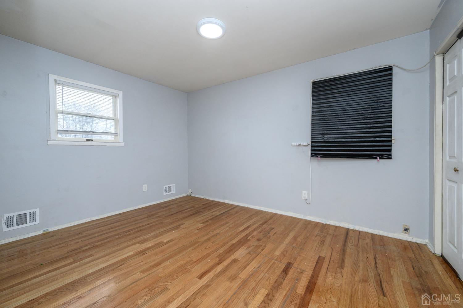 186 Central Avenue Edison, NJ 08817 - Photo 19 of 32 a view of empty room with wooden floor and fan