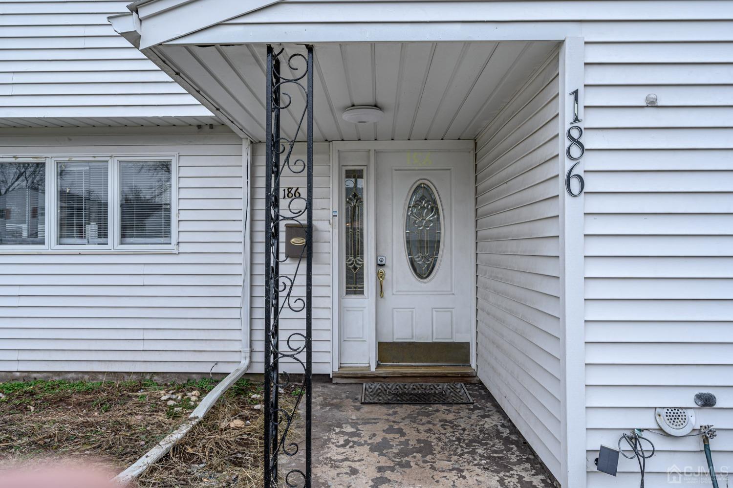 186 Central Avenue Edison, NJ 08817 - Photo 2 of 32 a view of a house with a door and wooden walls