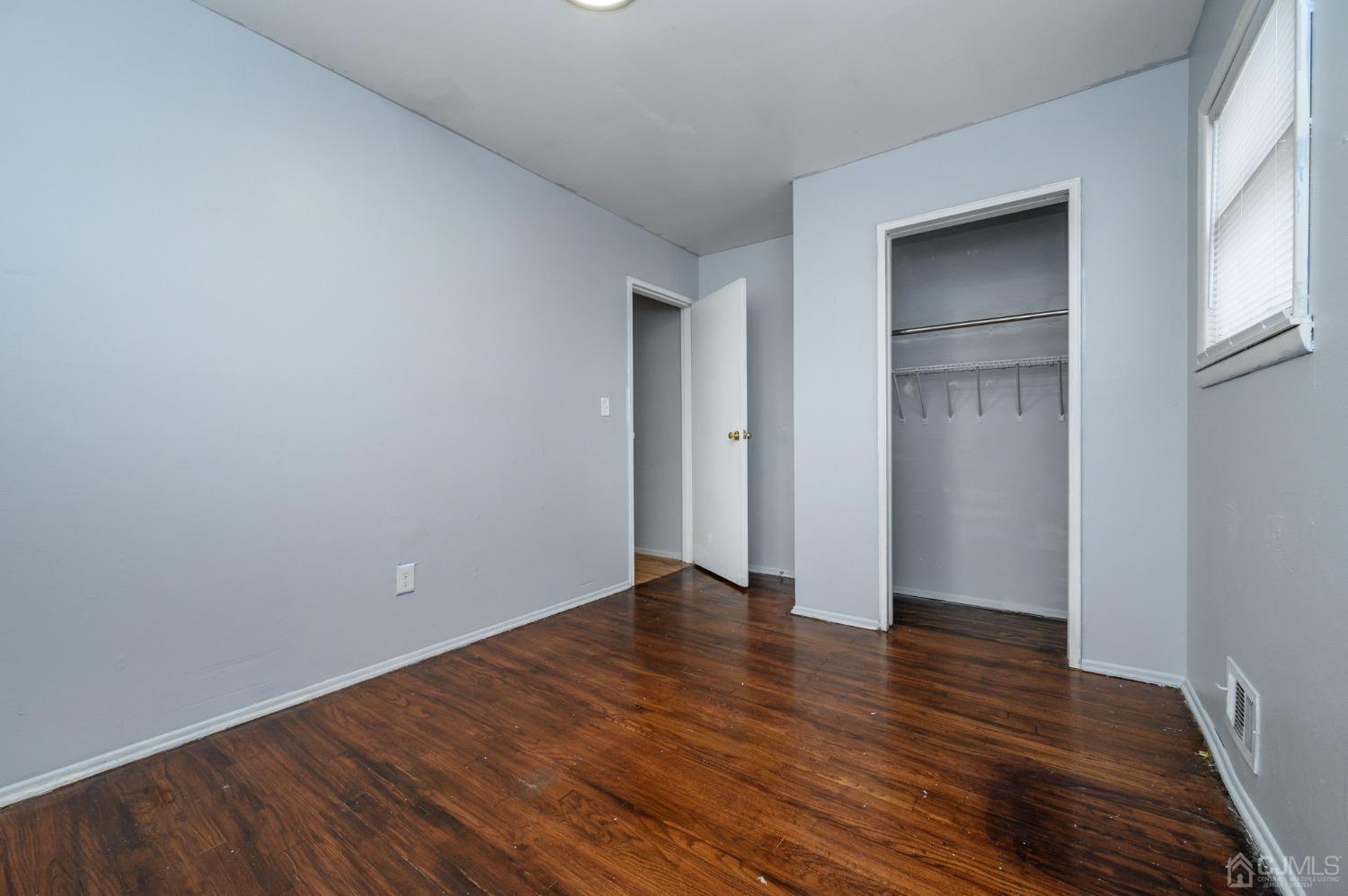 186 Central Avenue Edison, NJ 08817 - Photo 25 of 32 a view of an empty room with wooden floor and closet
