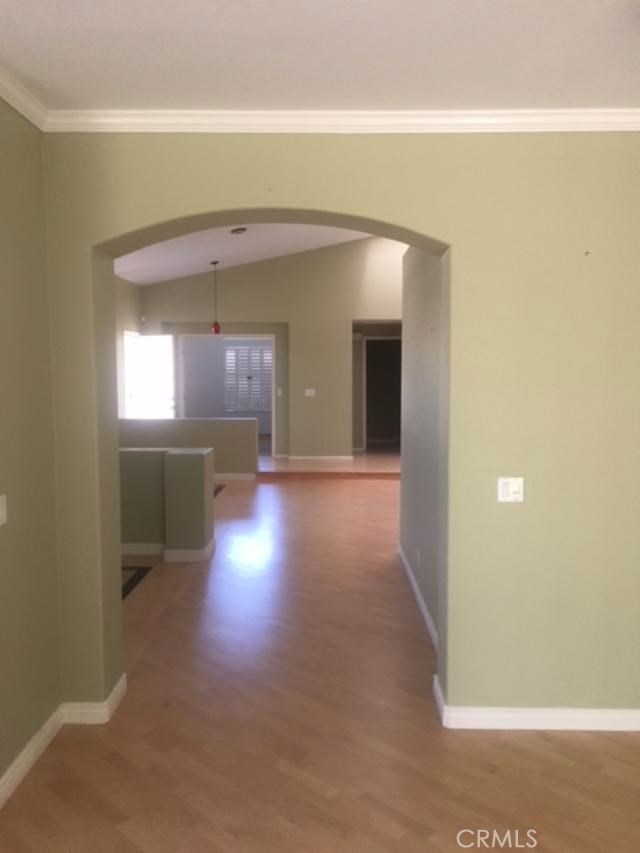 32184 Corte Daroca Temecula, CA 92592 - Photo 5 of 10 a view of a hallway with wooden floor and a living room