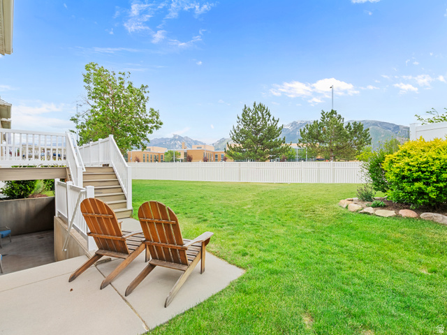 11881 Cottage View Lane Draper, UT 84020 - Photo 22 of 29 Expansive fenced backyard featuring a manicured lawn, established landscaping, and a concrete patio