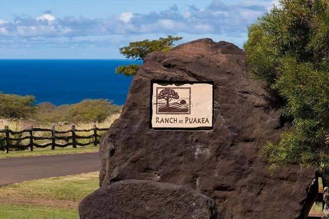 a sign that is sitting on a rock