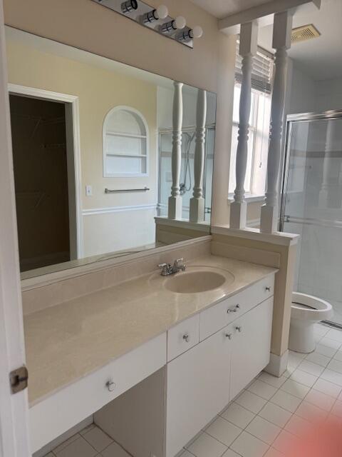 2509 Southeast Springtree Place Stuart, FL 34997 - Photo 13 of 19 a bathroom with a granite countertop sink a toilet and a mirror