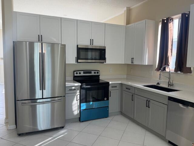 2509 Southeast Springtree Place Stuart, FL 34997 - Photo 6 of 19 a kitchen with stainless steel appliances granite countertop a refrigerator sink and stove