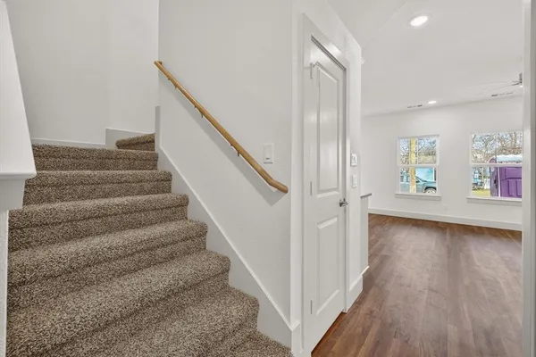 a view of entryway and hall with wooden floor