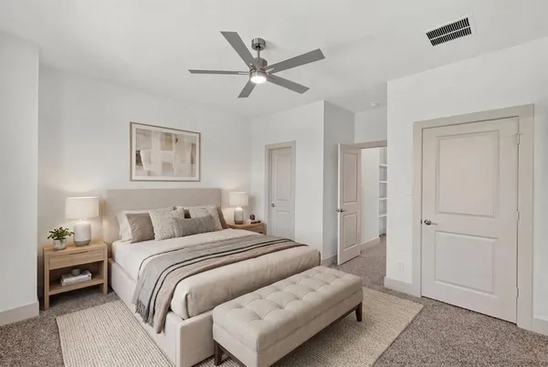 a bedroom with a bed and a ceiling fan