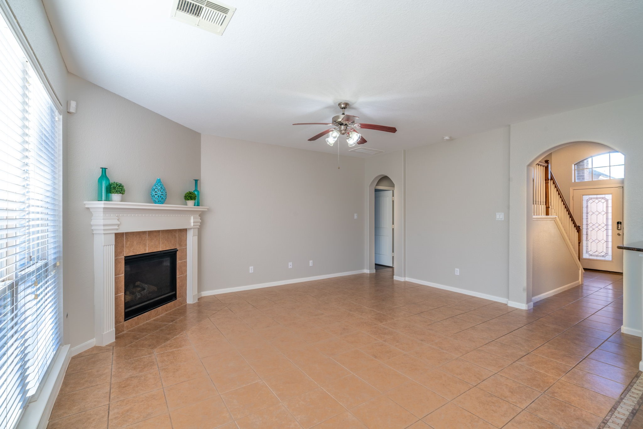 138 Magnolia Grove Lane Conroe, TX 77384 - Photo 14 of 43 an empty room with fan and fireplace
