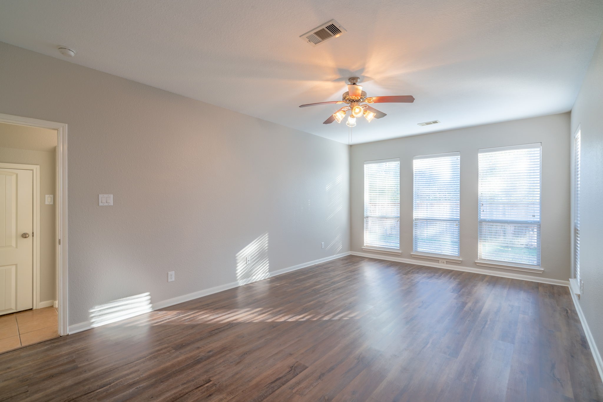 138 Magnolia Grove Lane Conroe, TX 77384 - Photo 18 of 43 a view of an empty room with a window and wooden floor